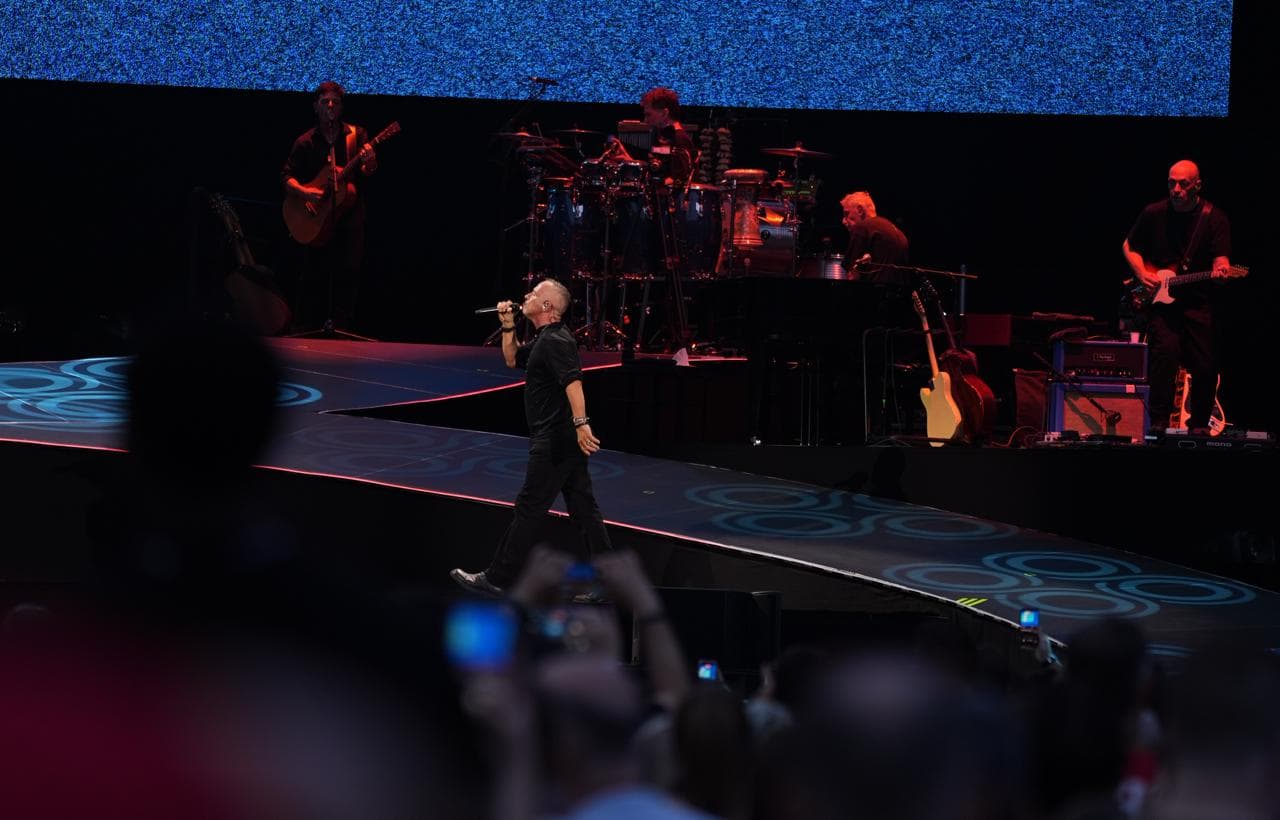 Eros Ramazzotti cammina sul palco davanti alla band
